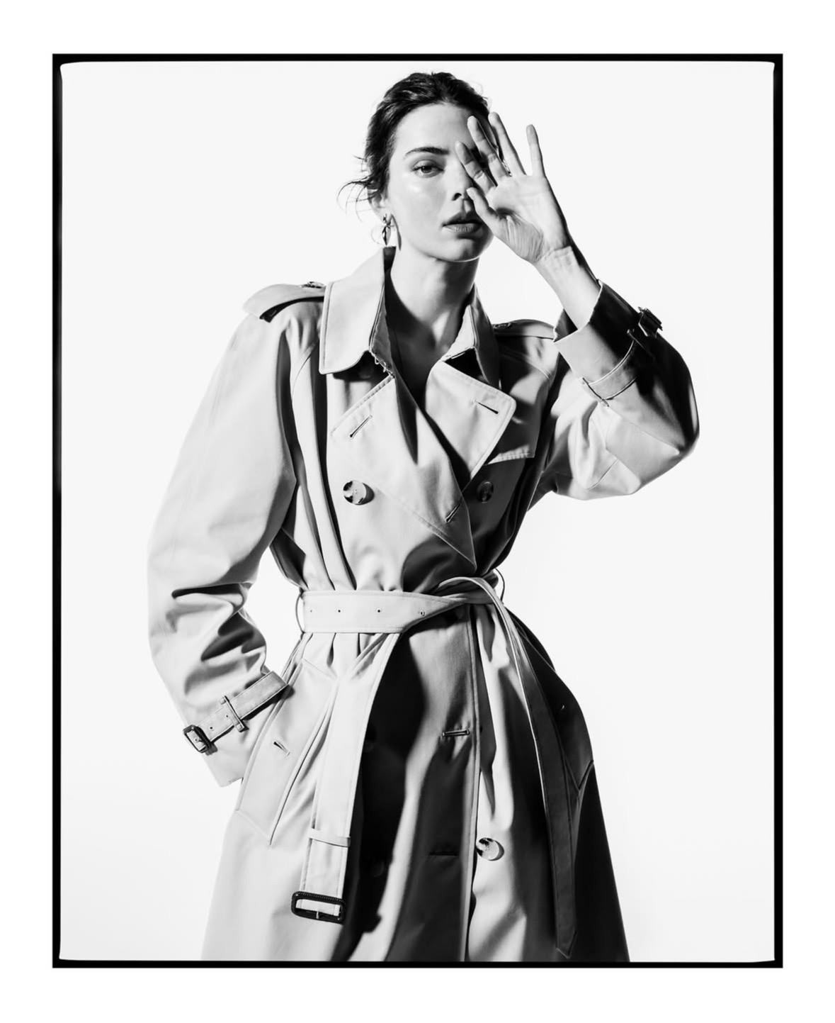 Kendall Jenner posa con una gabardina beige clásica de Burberry en una fotografía en blanco y negro.